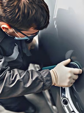 man touching up car exterior