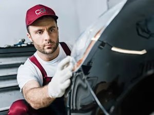 man looking at the front of car