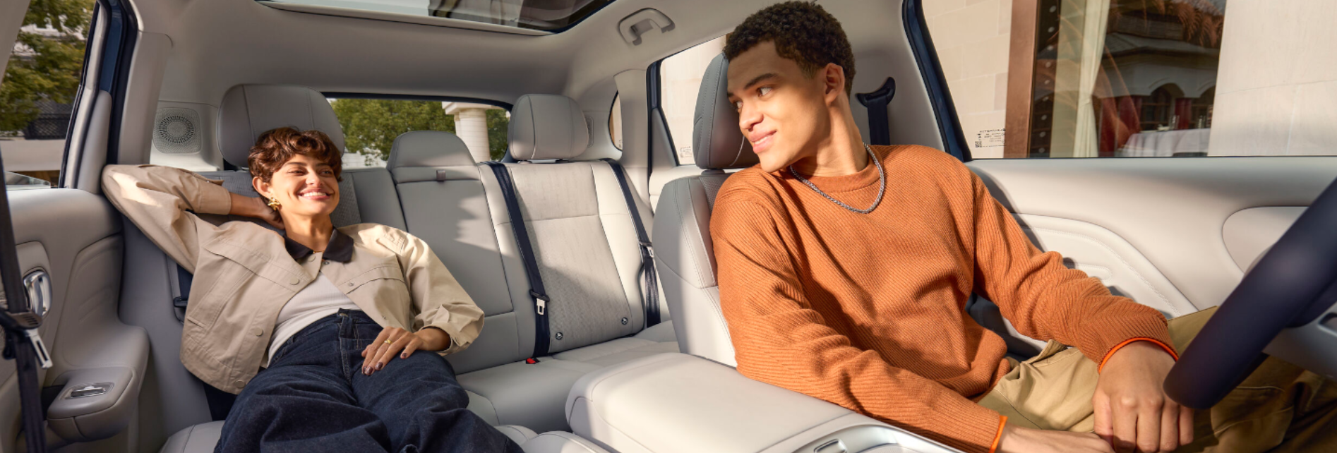 two people sat in the front seats of the car