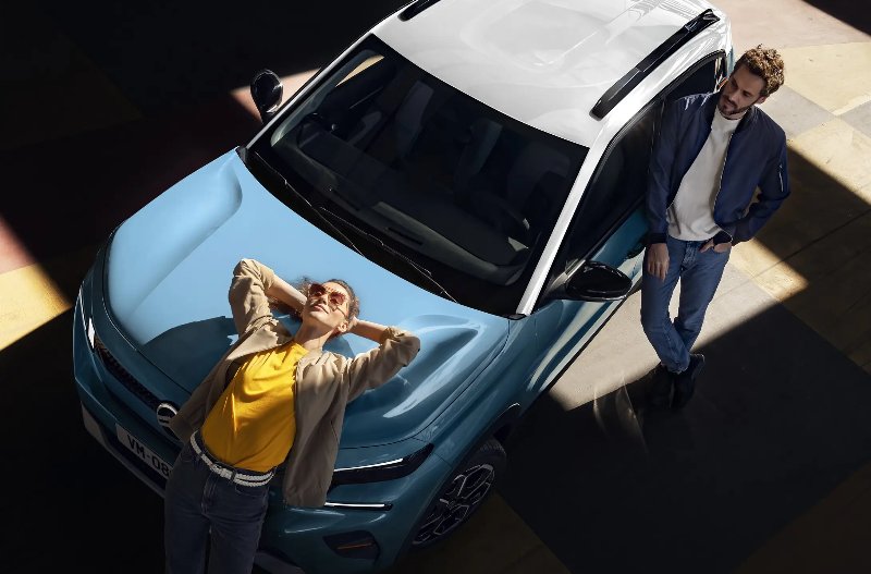 two people surrounding the car