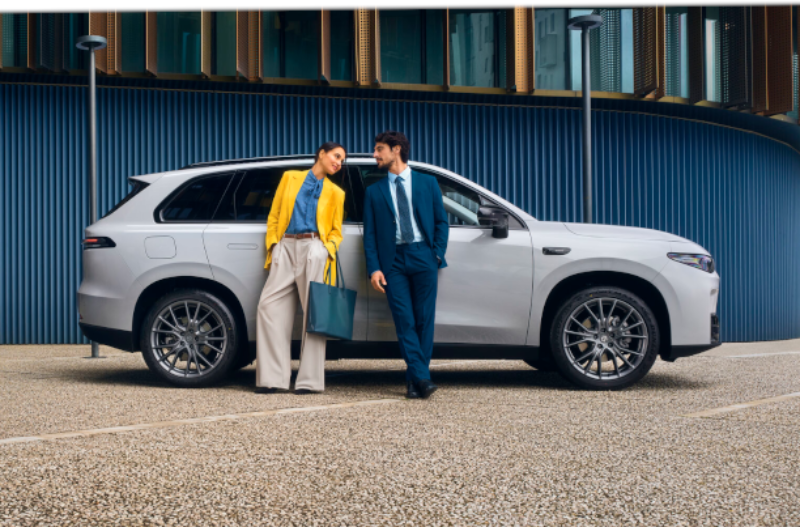 two people outside of a car