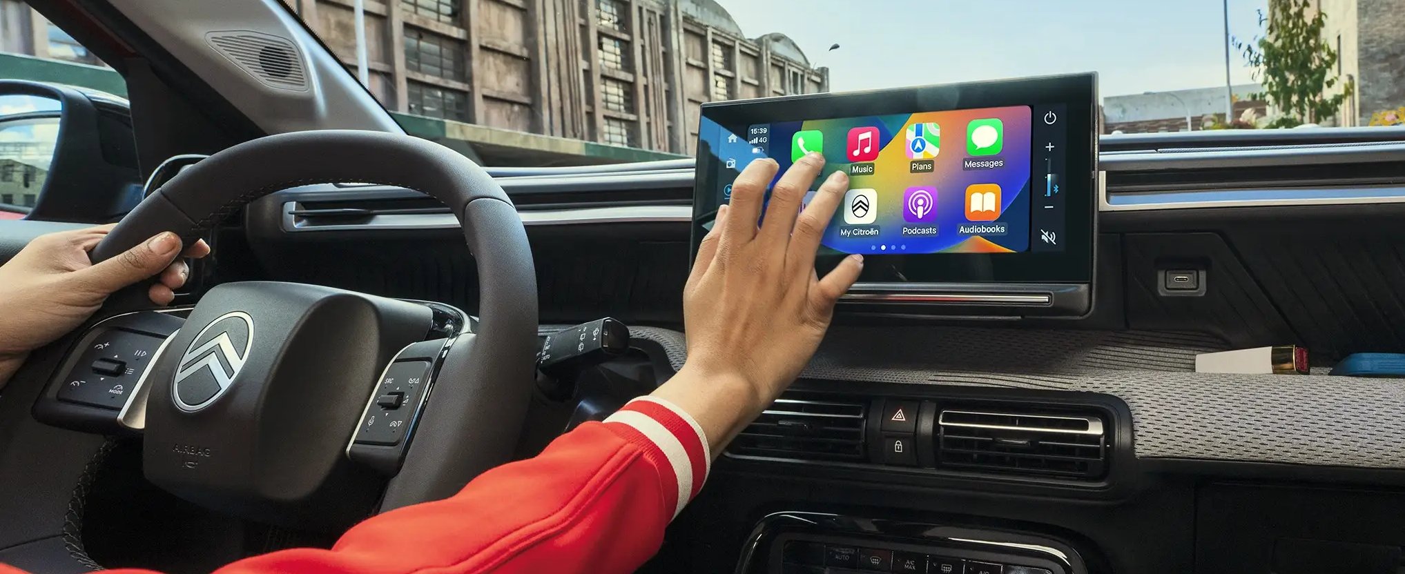person touching the central console screen