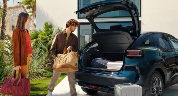 two people filling up the boot of the car