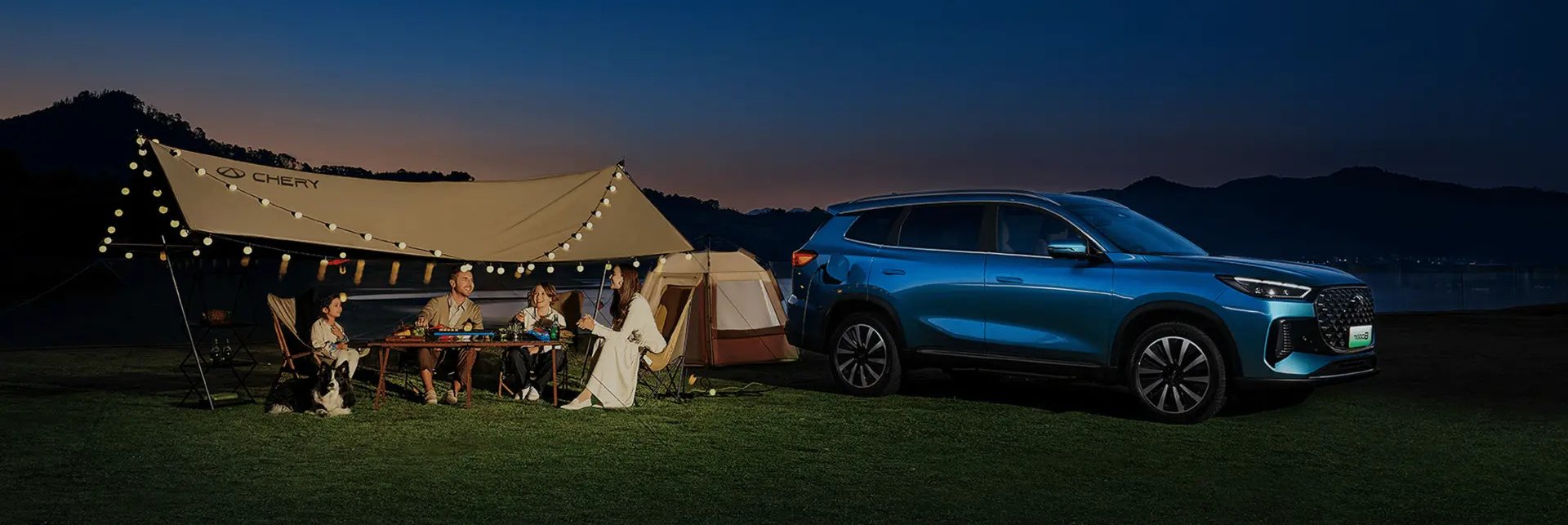 family camping outside in a tent with car parked