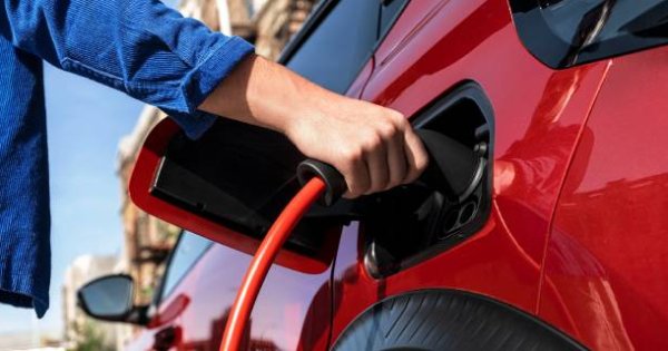 cloee up of someone putting car on charge