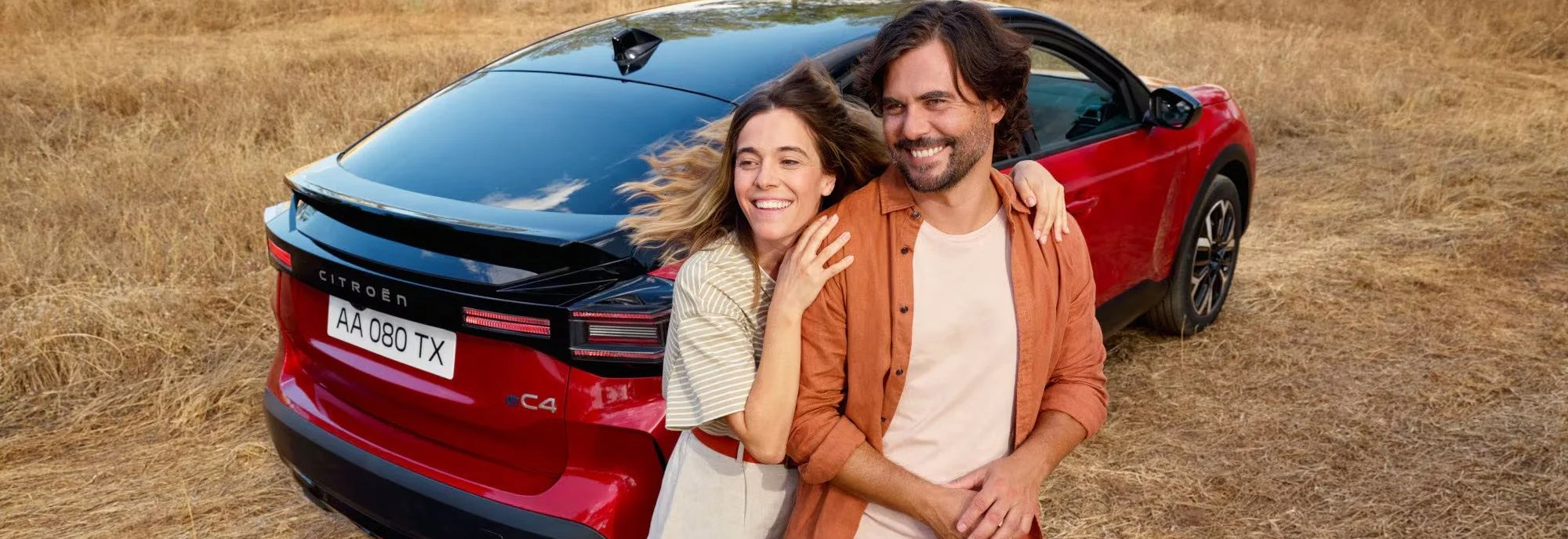 two people stood in front of the back end of a car