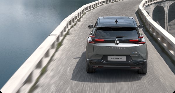 car driving down a road above the water
