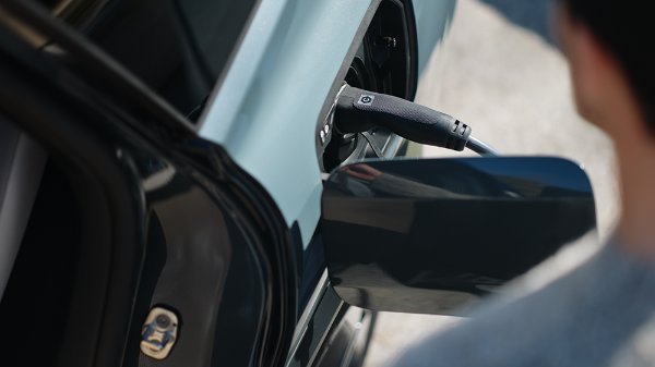 close up of someone in putting a charger in car