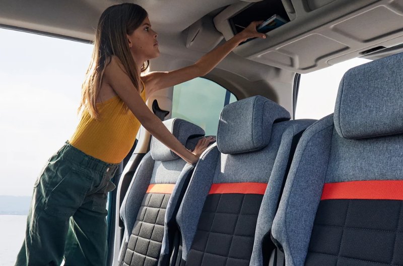person looking for something in the back of a car