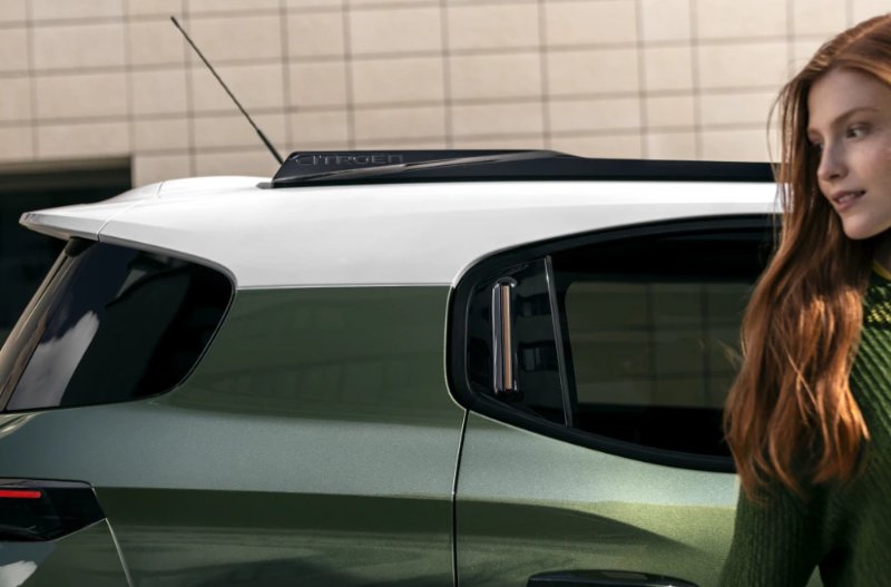 Woman standing next to a car