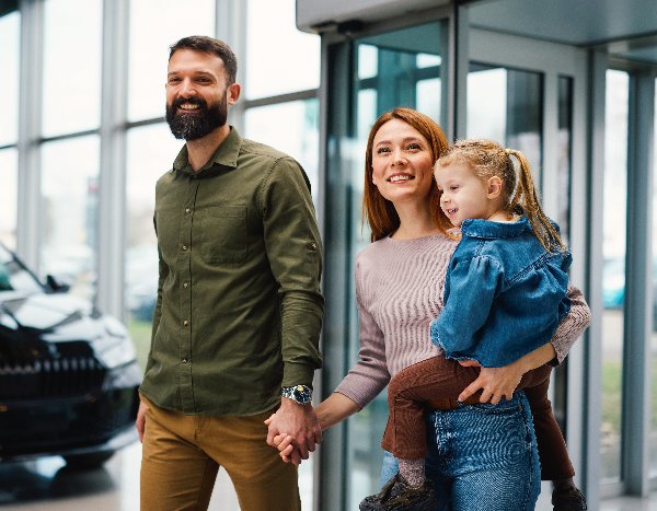 couple walking into dealership
