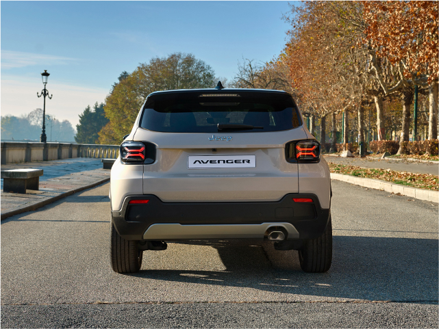 Rear view of a silver Jeep Avenger SUV parked on a road.