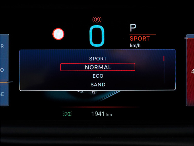 Car dashboard showing driving modes: Sport, Normal, Eco, Sand, with Normal selected.