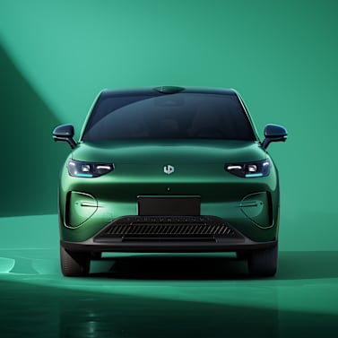 Green electric car viewed from the front.