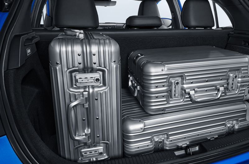 suitcases in the boot of a blue car
