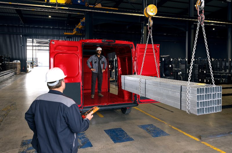 two people directing some steel into the boot