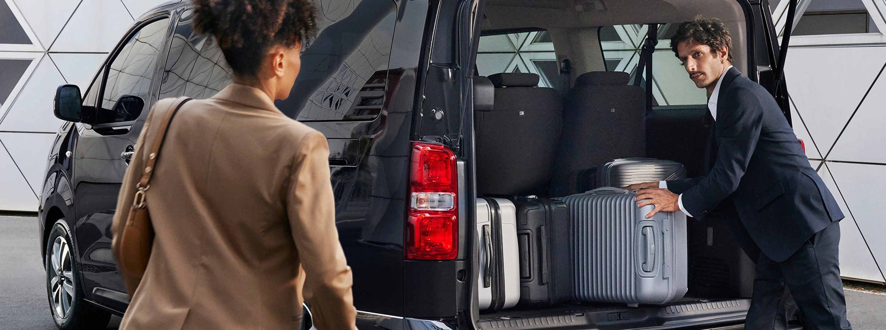 two people putting things in the boot of the car